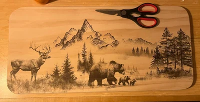 Elk, bear and cubs with mountains and pines on a long maple board